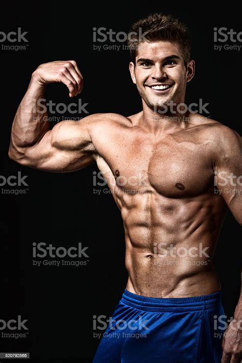 Cheerful Muscular Man Flexing Muscle Stock Photo Download Image Now