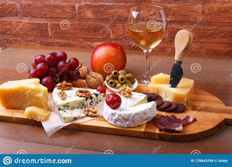 Assortment Of Cheese With Fruits Grapes Nuts Glass With Wine And