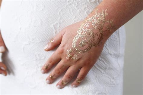 Long lasting and easy to apply. Gold henna hand temporary tattoo | Gold henna, Bohemian ...