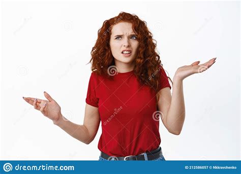 Confused Redhead Girl Cant Understand Something Shrugging Shoulders And Frowning Puzzled