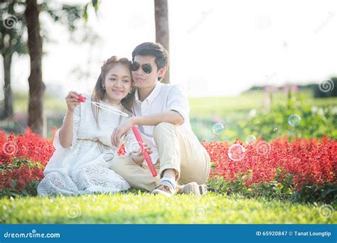 Asia Beautiful Young Loving Couple In Blossom Spring Garden Stock