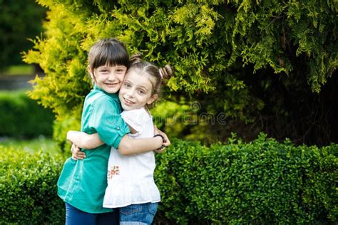 Two Cute Girls Emotionally Spend Time In The Nature Girls Of School