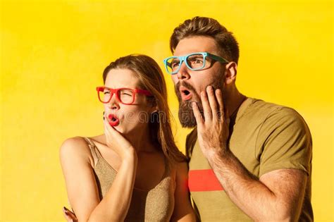 Amazed Couple In Glasses Looking Away With Astonished Facial Expression