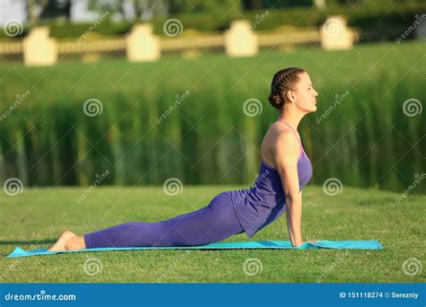 Beautiful Young Woman Practicing Yoga Outdoors In The Morning Stock