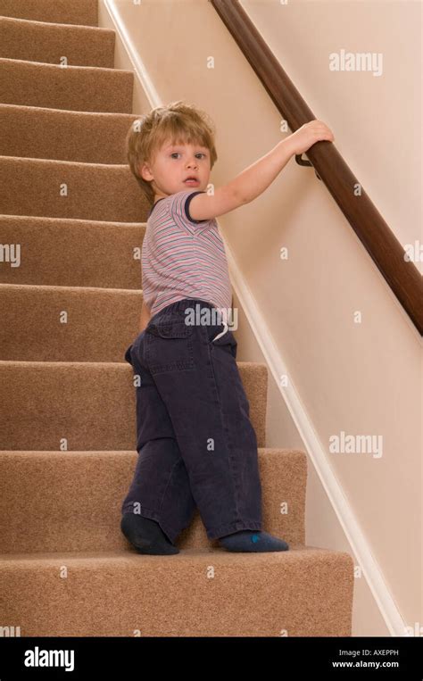 Two Year Old Boy Climbing The Stairs Stock Photo Alamy