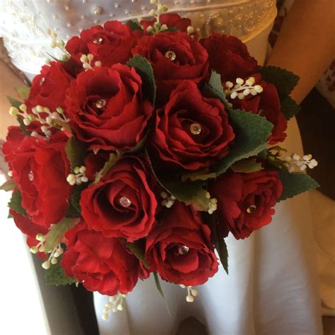 A Brides Wedding Bouquet Featuring Artificial Silk Red Roses