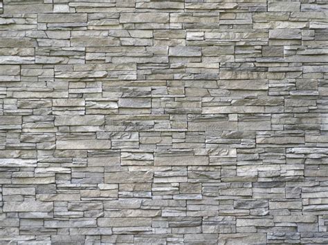 Stone Cladding Wall Made Of Striped Stacked Slabs Of Natural Gray Rocks