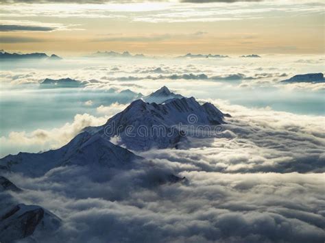 Amazing Aerial View Of Misty Swiss Alps And Clouds Above The Mountain