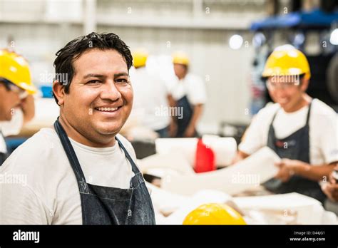 Worker Smiling In Manufacturing Plant Stock Photo Alamy