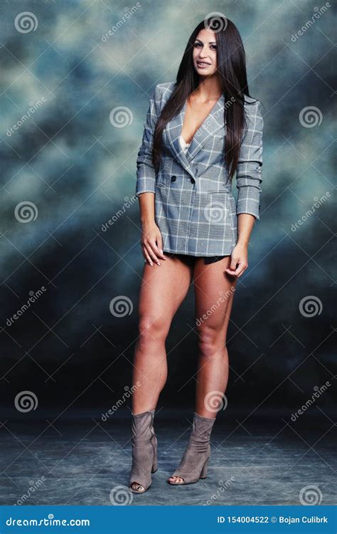 Beautiful And Attractive Brunette Girl Posing In Studio Stock Photo