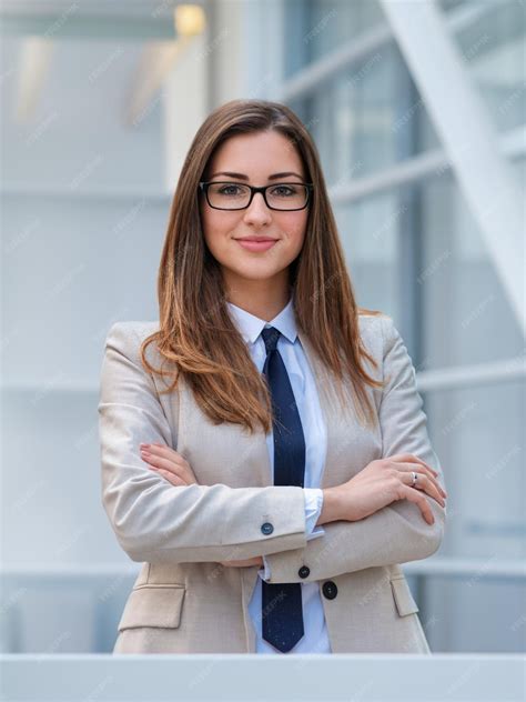 Premium Ai Image Smiling Confident Businesswoman Posing With Arms Folded