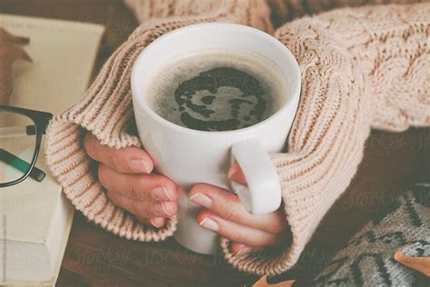 Cozy Home Woman Warming Up Her Hands With Coffee Mug By Stocksy