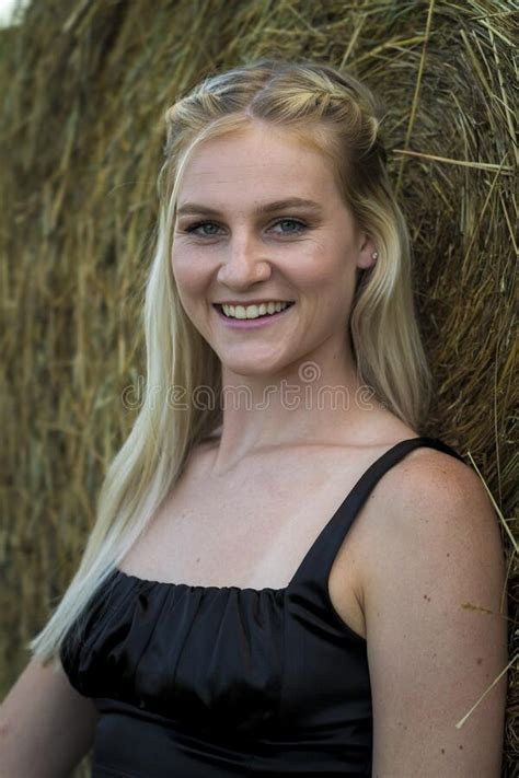 a lovely blonde model poses outdoors in a farm environment stock image image of farmers