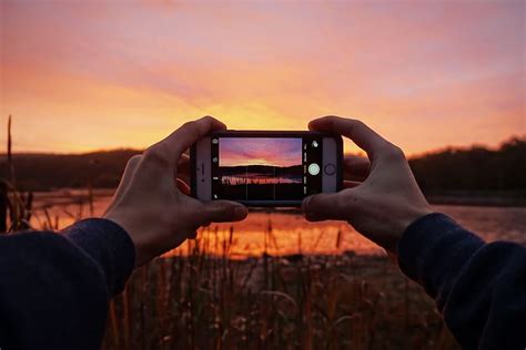 Hd Wallpaper Man Capturing A Stunning Sunset With His Mobile Iphone