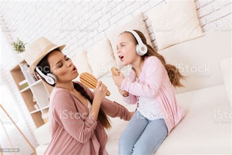 Must be something in the water or that i'm my mother's daughter. Mom And Daughter Sing Songs At Home Stock Photo - Download Image Now - iStock
