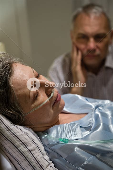 Dying Old Woman In Hospital Bed With Caring Man Royalty Free Stock Image Storyblocks