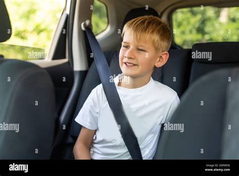Young Little Boy Buckled Up With Seatbelt Inside The Car Stock Photo