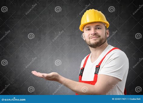 Worker Looking At Camera And Showing Copy Space With His Hand Stock