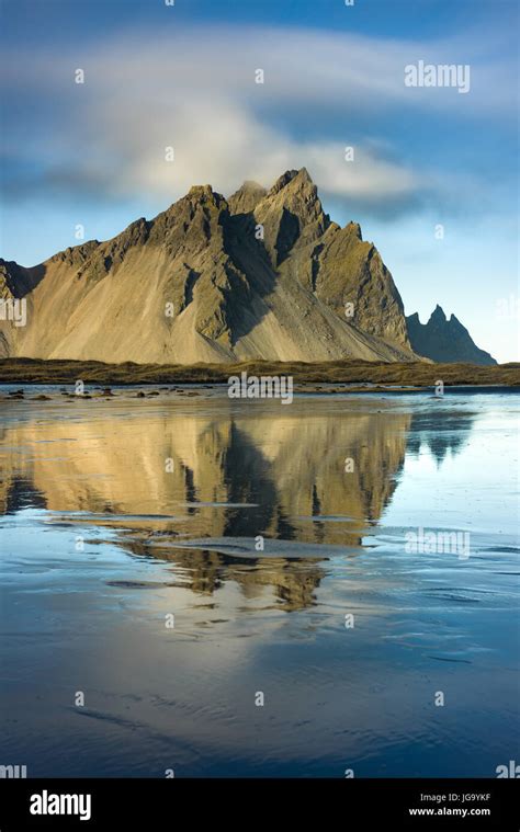 Stokksnes And Vestrahorn Mountains In Late Afternoon Light Reflected In