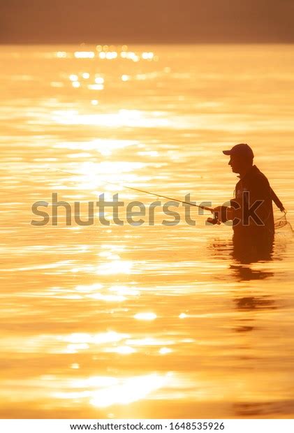 Unrecognizable Silhouette Man Fishing Sunset Stock Photo 1648535926