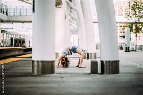 Side View Of Girl Bending Over Backwards At Railroad Station Platform