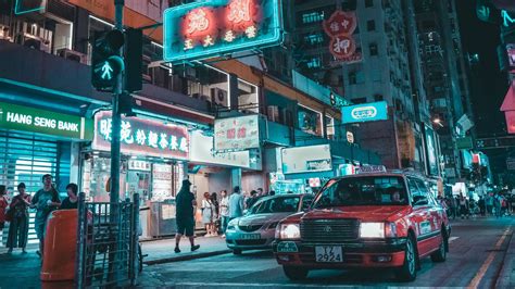 Download Aesthetic Red Taxi In Neon City Wallpaper