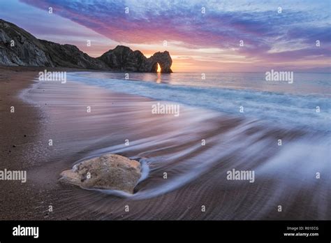 Durdle Door At Sunrise Jurassic Coast Dorset England Stock Photo Alamy