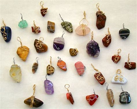 A Collection Of Different Colored Stone And Metal Items On A White