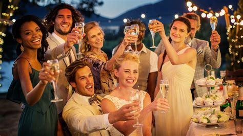 Happy wedding guests in the beach wedding ceremony in cyprus, as the couple face each other during their wedding ceremony. 4 Things Wedding Guests Absolutely Hate | Glamour