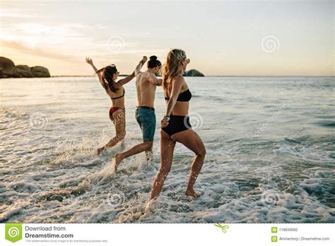 Friends Holding Hands And Running At Beach Stock Photo Image Of Caucasian Group