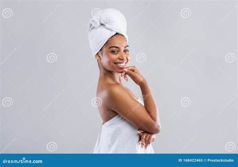 Cheerful Young Black Woman Wrapped In White Bath Towels Stock Image