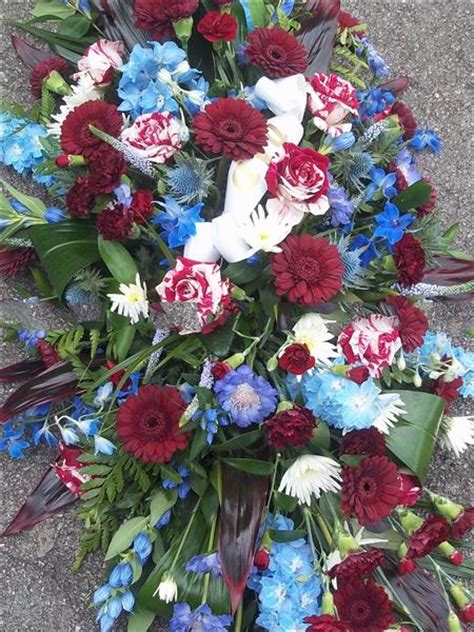 Any letters are available £50.00 a letter. Claret and Blue Casket Spray - Funeral Flowers Great Barr