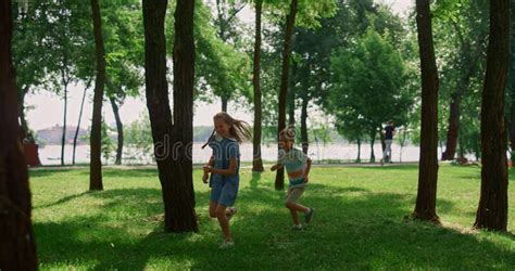 Laughing Children Running On Sunny Meadow Happy Kids Play Catch Up In