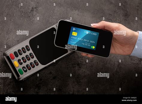 Transaction Completed On Terminal With Mobile Credit Card Stock Photo