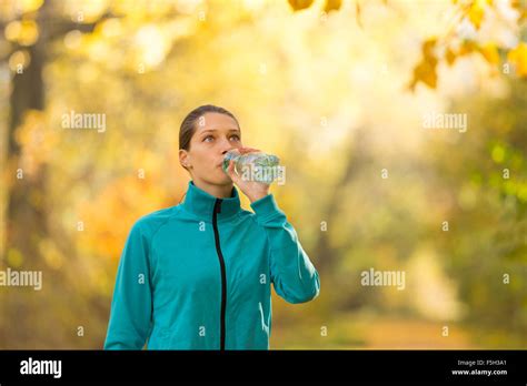 Portrait Of Young Brunette Woman Drinking Water Stock Photo Alamy
