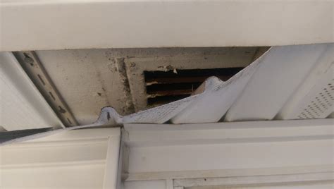 Slide the vent cap through the hole. How can I vent my kitchen exhaust through vinyl soffit ...