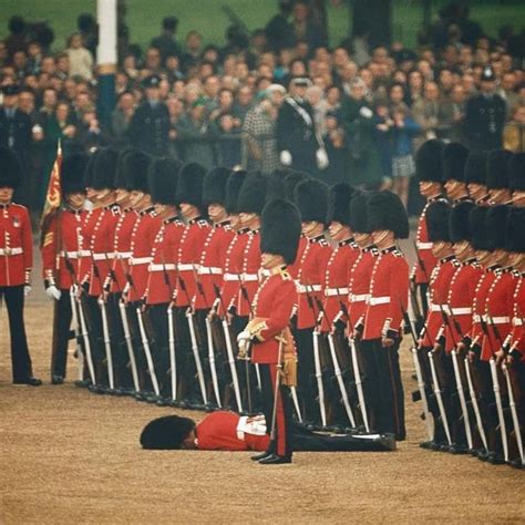 Irish Guards Remain At Attention After A Fellow Guardsman Faints In