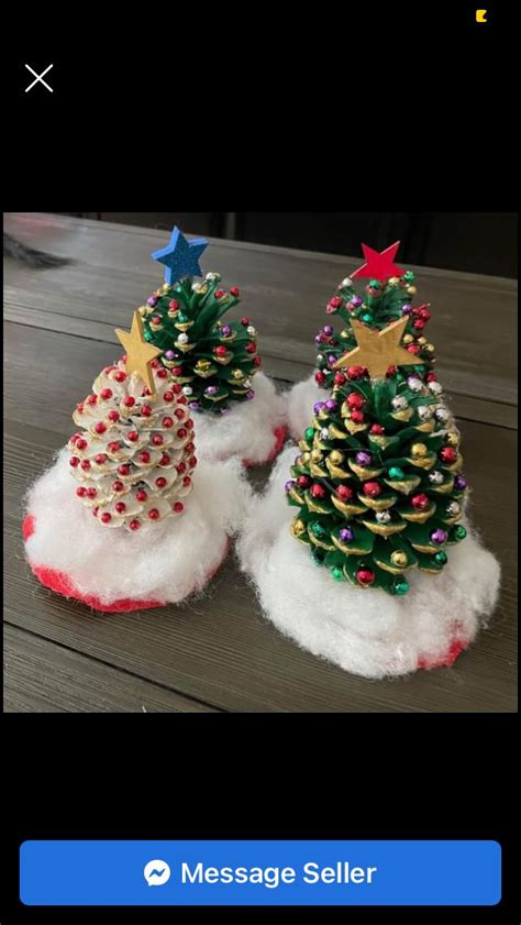 Two Small Christmas Trees Made Out Of Pom Poms