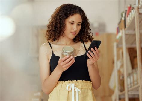 Customer Shopping Browsing Phone And Picking Supermarket Product