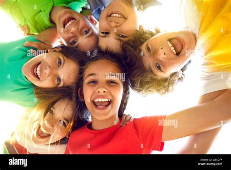 Group Of Happy Little Children Playing Together Having Fun Huddling
