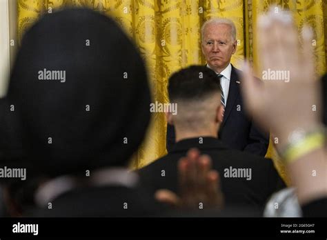 Us President Joe Biden Stands As A New Group Of Naturalized American