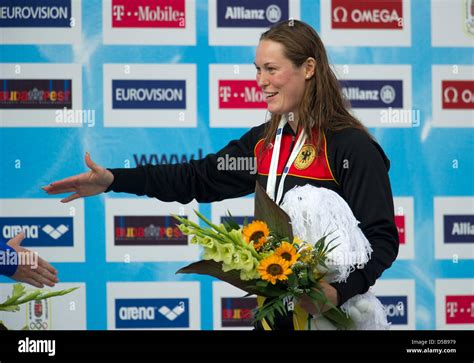 german swimmer jenny mensing reaches out her hands during the award ceremony after taking third