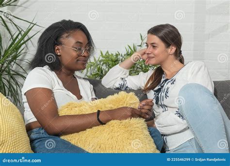 Young Beautiful Mixed Race Lesbian Couple Of Black African And Caucasian Woman Sitting On The