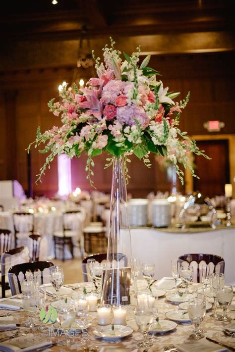 *first consultation is included free of charge with your wedding & reception floral arrangement package, subsequent consultations may be scheduled for an additional fee. Tall glass cylinder centerpiece with pink hydrangea, dark ...