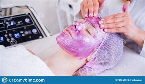 Cosmetologist Making Massage The Skin Of The Forehead Woman In A Spa Salon On Cosmetic
