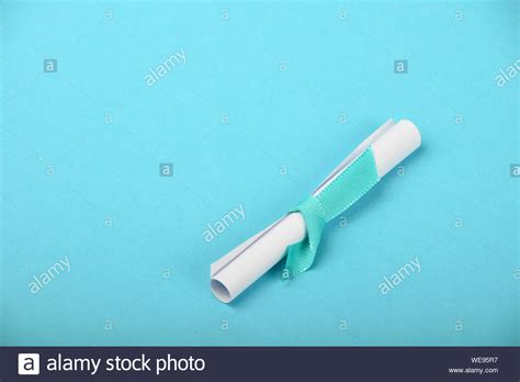 Close Up Of Scroll Of Paper Over Blue Background Stock Photo Alamy
