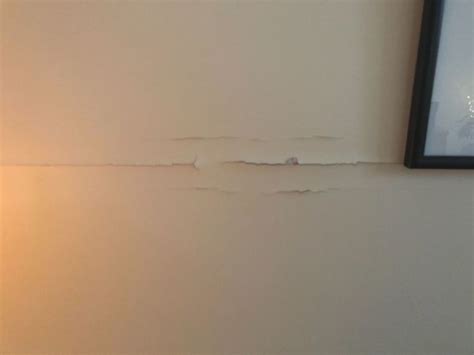 Get a drywall repair tool kit and the right materials before starting to repair a drywall ceiling. How do I repair a drywall tape crack on my living room ...