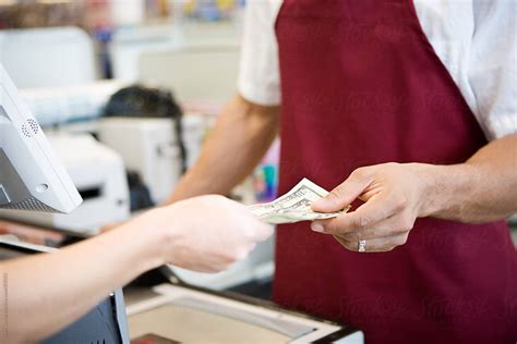 Supermarket Cashier Taking Cash Payment Stocksy United