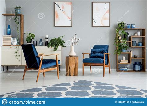 Blue Carpet In Grey Living Room Interior With Posters And Wooden Table