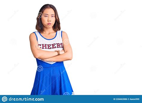 Young Beautiful Chinese Girl Wearing Cheerleader Uniform Skeptic And